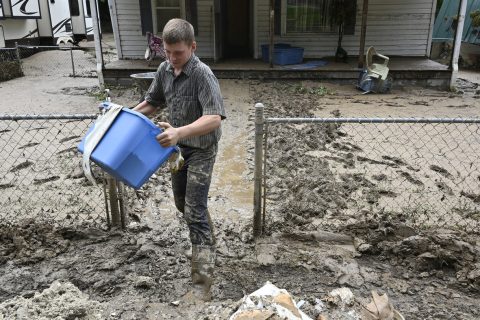 Members of the local Mennonite community remove mud filled debris from homes following flooding at Ogden Hollar in Hindman, Ky., Saturday, July 30, 2022. (AP Photo/Timothy D. Easley)