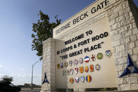 FILE - In this July 9, 2013, file photo, traffic flows through the main gate past a welcome sign in Fort Hood, Texas. U.S. officials say the Army plans to put a civilian in charge of the command that conducts criminal investigations, in response to widespread criticism that the unit is understaffed, overwhelmed and filled with inexperienced investigators.(AP Photo/Tony Gutierrez, File)